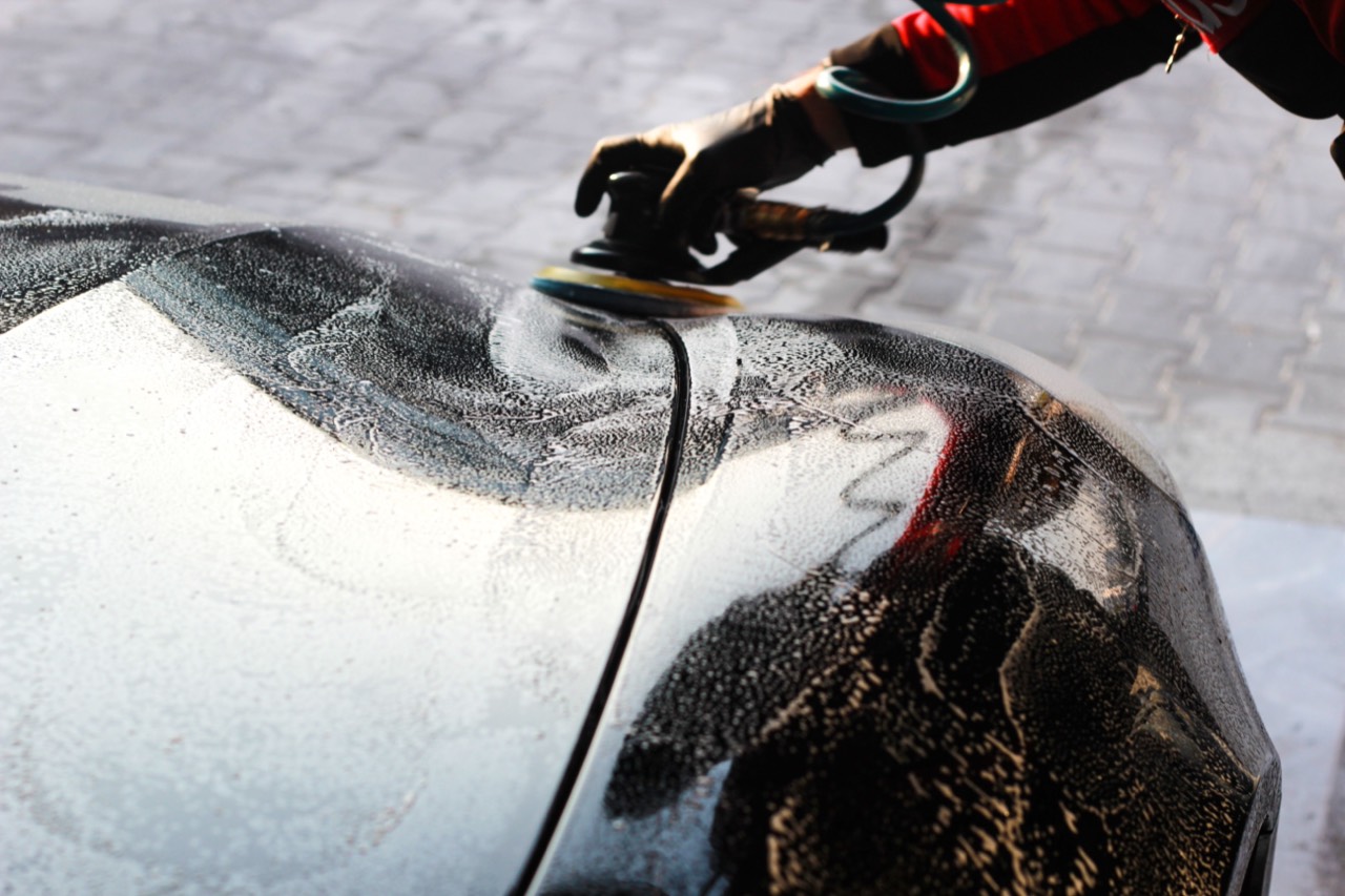 A car's paint being machine polished