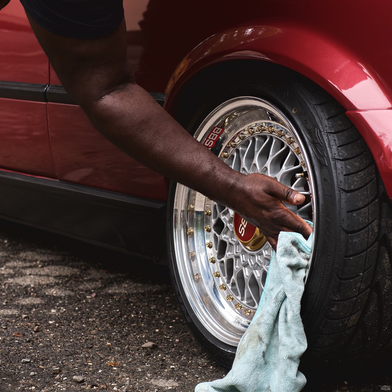 A wheel and tire being detailed by hand